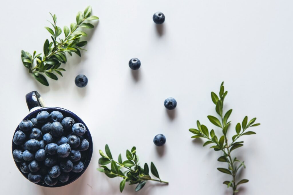 Blueberry explosion. Photo of blueberry in cup on white table. Top view. Healthy food, health